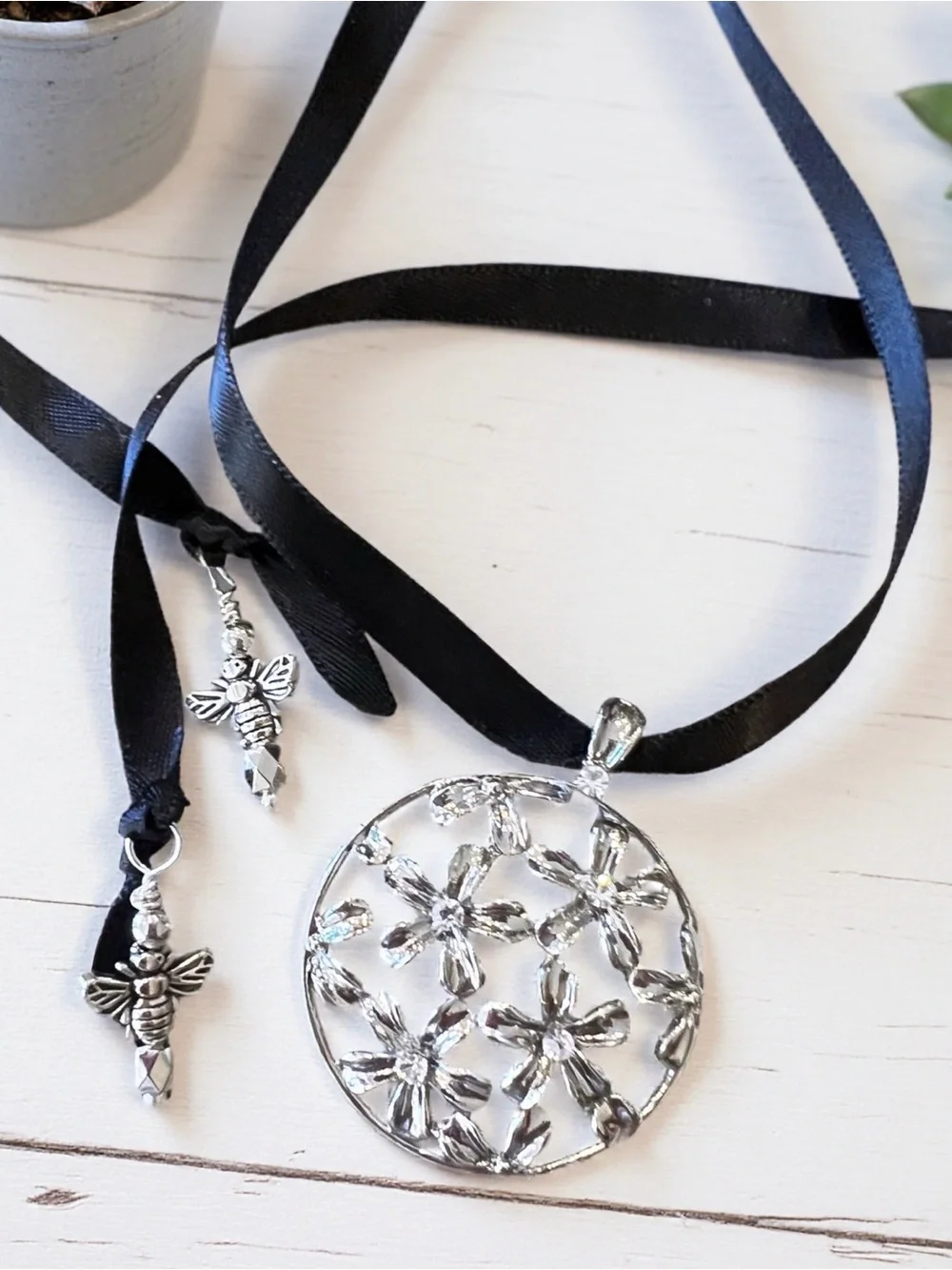 Silver Toned Floral Cutout Pendant Necklace on Black Satin Ribbon